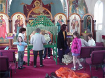 The woman of the church decorate the tomb.
