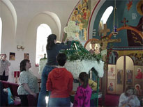 The woman of the church decorate the tomb.