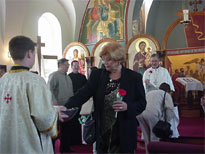 Mother's recieve bread as they leave the church.