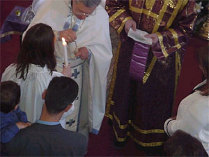 Father Andrew anoints.