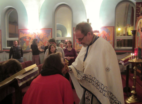 Father Paul blesses parishioneer.