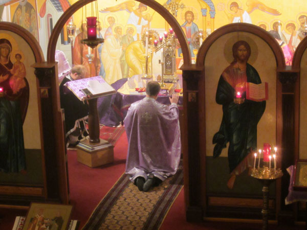Parishioners prostrate before the Light Of Christ.
