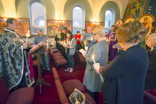 Father Paul and Deacon prepare for the readings of the Passion Gospels .