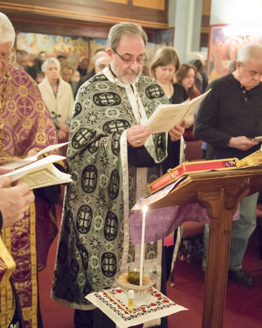 Clergy pray over Holy Oil .