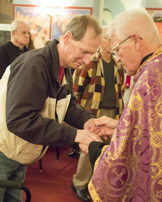 Father Paul anoints parishioner with the Oil of Holy Unction .