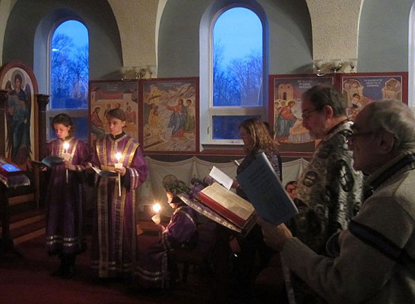 Father Paul and Deacon prepare for the readings of the Passion Gospels .