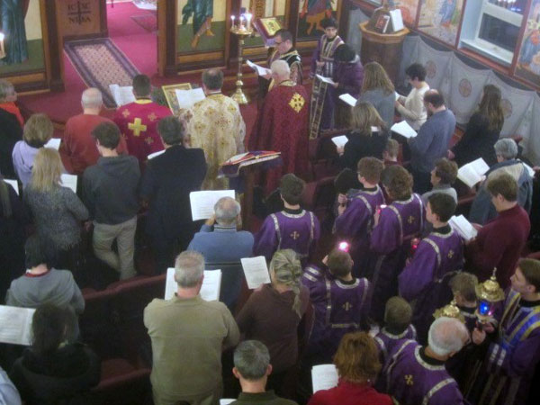 Clergy pray over Holy Oil .