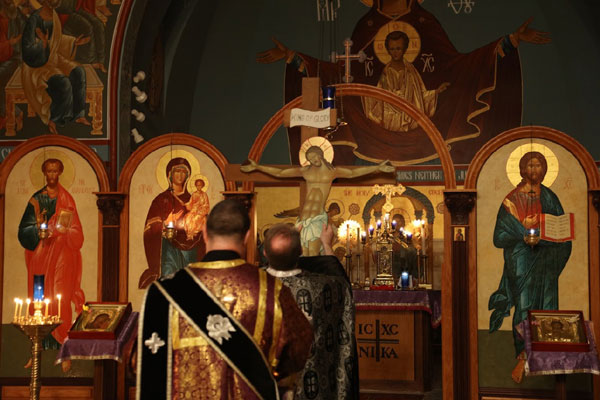 Father Paul and Deacon 
prepare for the readings of the Passion Gospels .