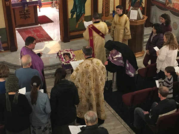 Clergy pray over Holy Oil .