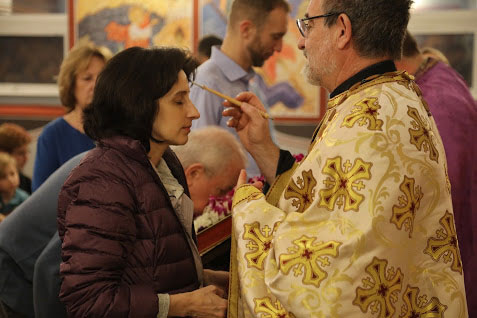 Father Paul anoints parishioner with the 
Oil of Holy Unction .